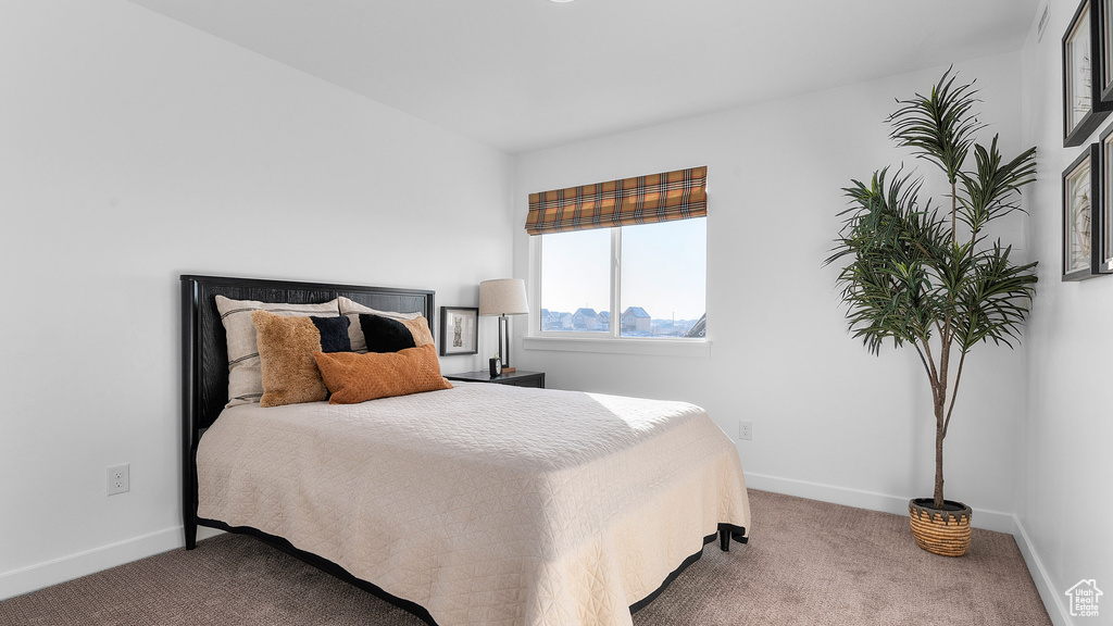 Carpeted bedroom with baseboards
