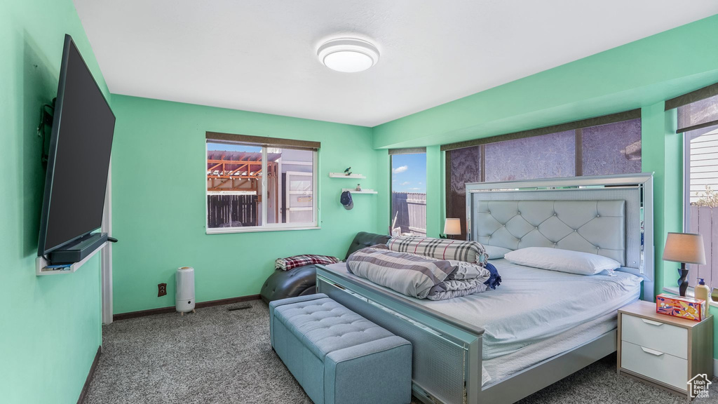 Bedroom featuring baseboards and carpet