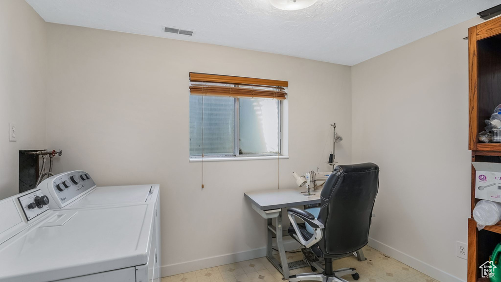 Laundry room featuring baseboards, visible vents, washing machine and clothes dryer, and light floors
