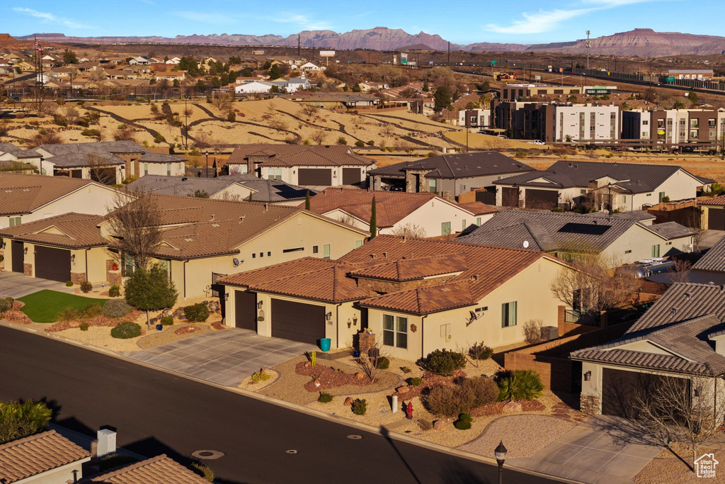 Birds eye view of property with a mountain view and a residential view