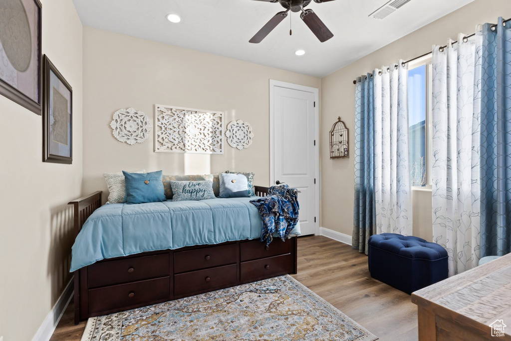 Bedroom with recessed lighting, visible vents, wood finished floors, and baseboards