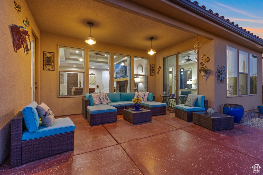 Patio terrace at dusk featuring an outdoor living space