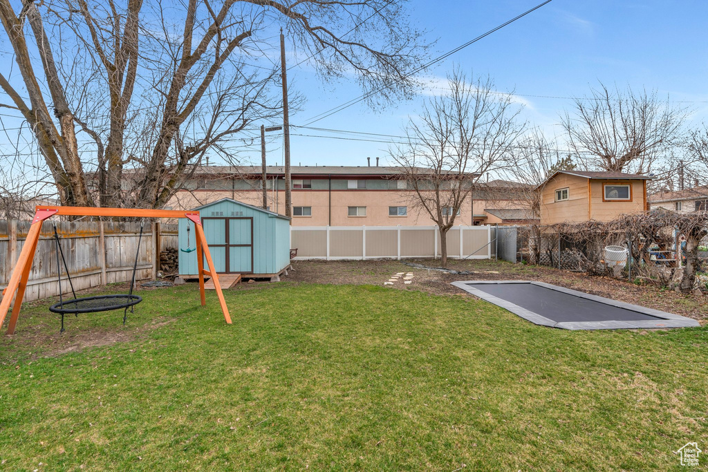 View of yard with an outbuilding, a fenced backyard, and a storage shed