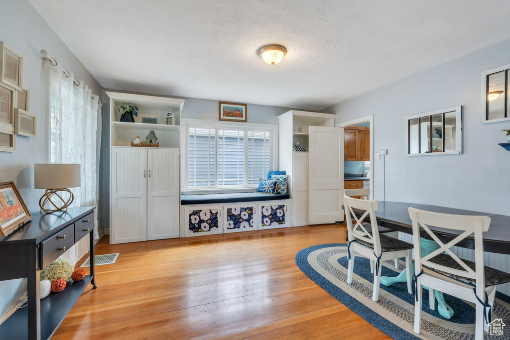 Dining area featuring visible vents, a healthy amount of sunlight, and light wood finished floors