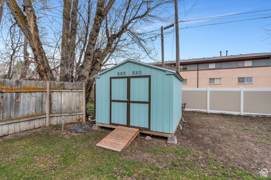 View of shed with a fenced backyard