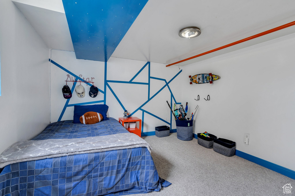 Carpeted bedroom featuring baseboards