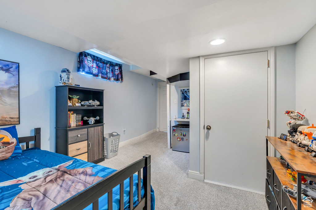 Bedroom featuring light colored carpet and baseboards