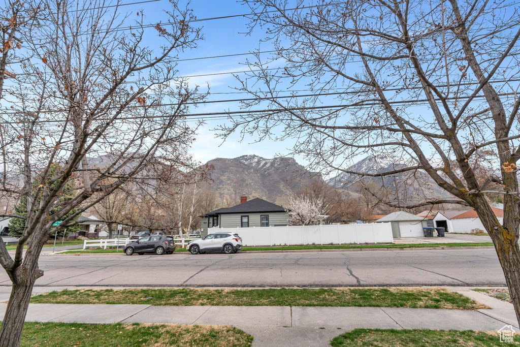 View of yard featuring fence and a mountain view
