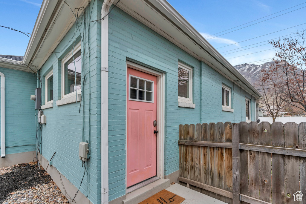Property entrance with fence and a mountain view