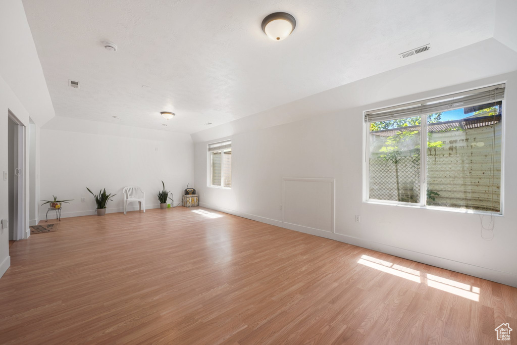 Empty room with light wood-type flooring and baseboards
