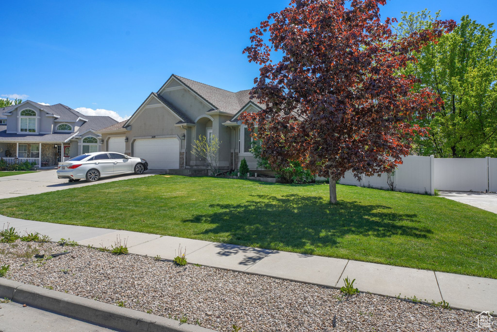 View of front of home featuring a garage and concrete driveway