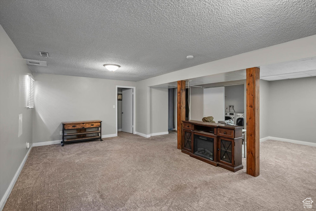 Finished basement with baseboards, carpet flooring, and visible vents