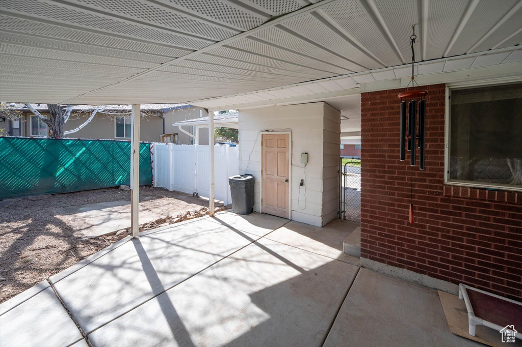 View of patio featuring fence