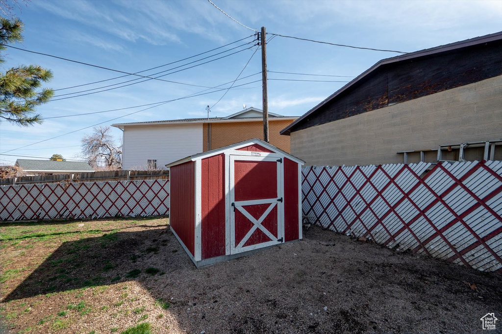 View of shed featuring fence