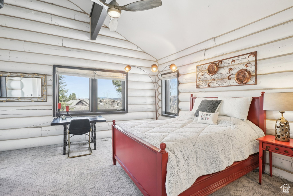 Carpeted bedroom featuring log walls