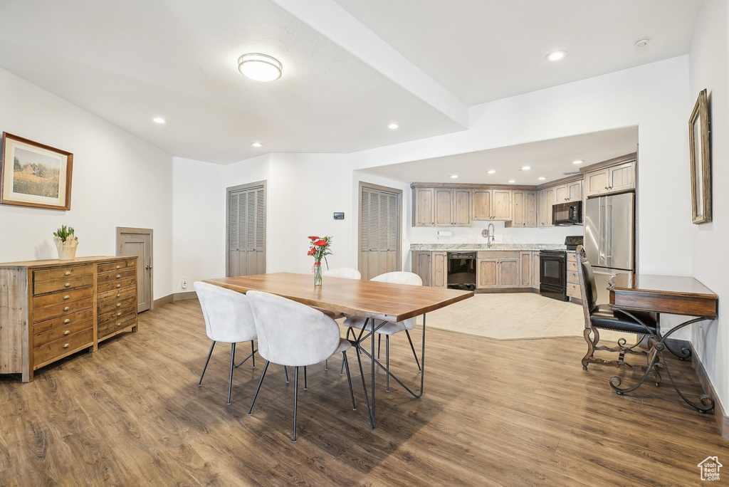 Dining room featuring wood finished floors, recessed lighting, and baseboards