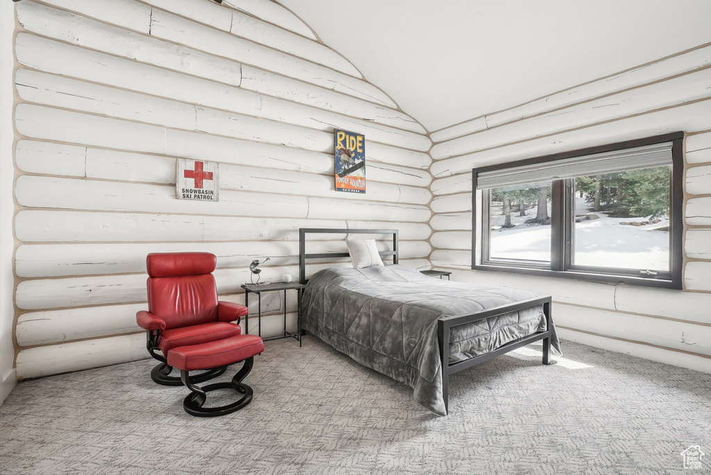 Carpeted bedroom featuring vaulted ceiling