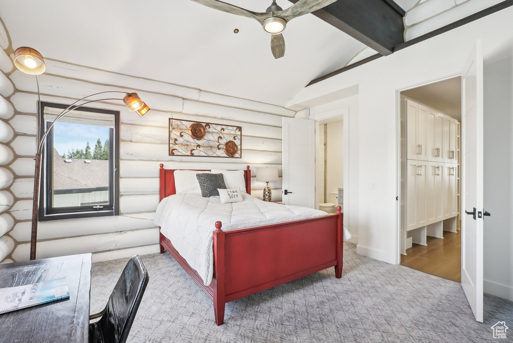 Bedroom with carpet floors, rustic walls, and ceiling fan