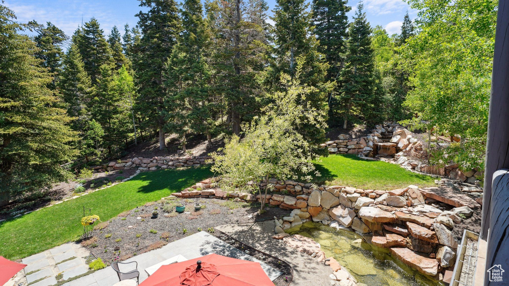 View of green lawn featuring a patio area