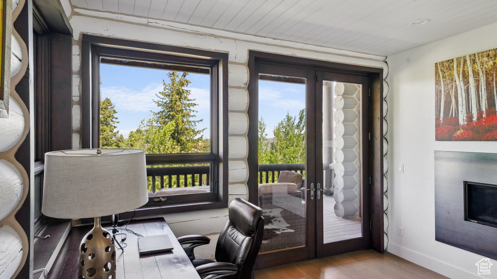 Office area with french doors, wood finished floors, baseboards, and wood ceiling