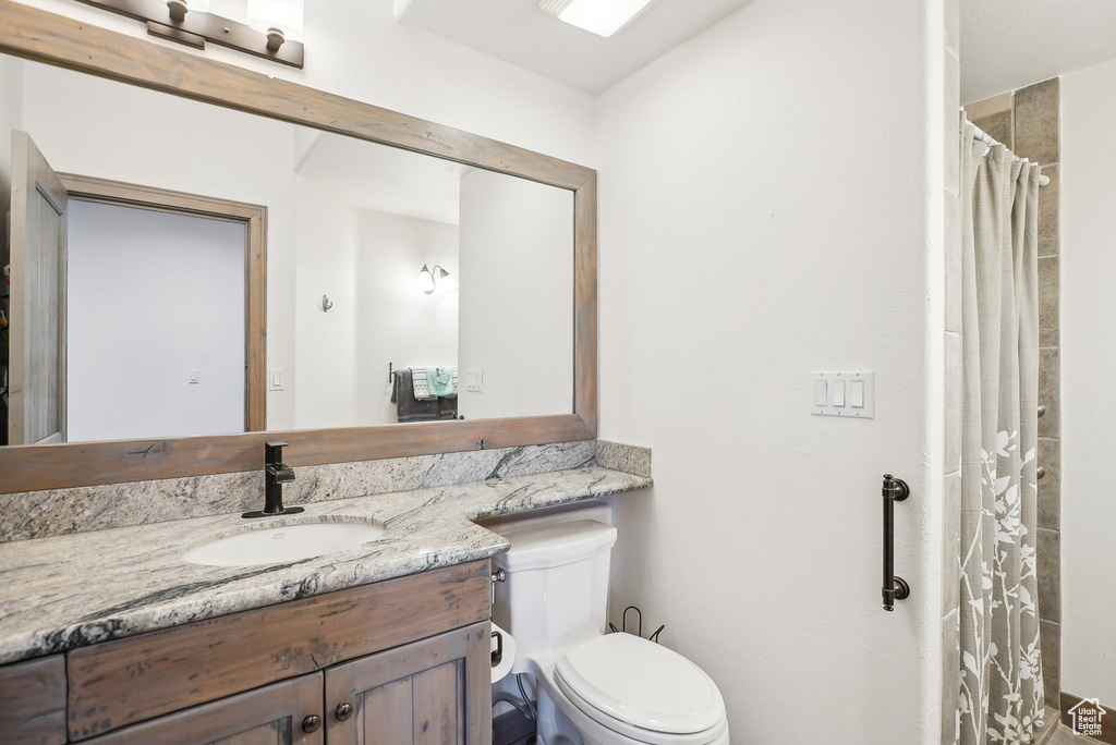 Bathroom featuring vanity and toilet