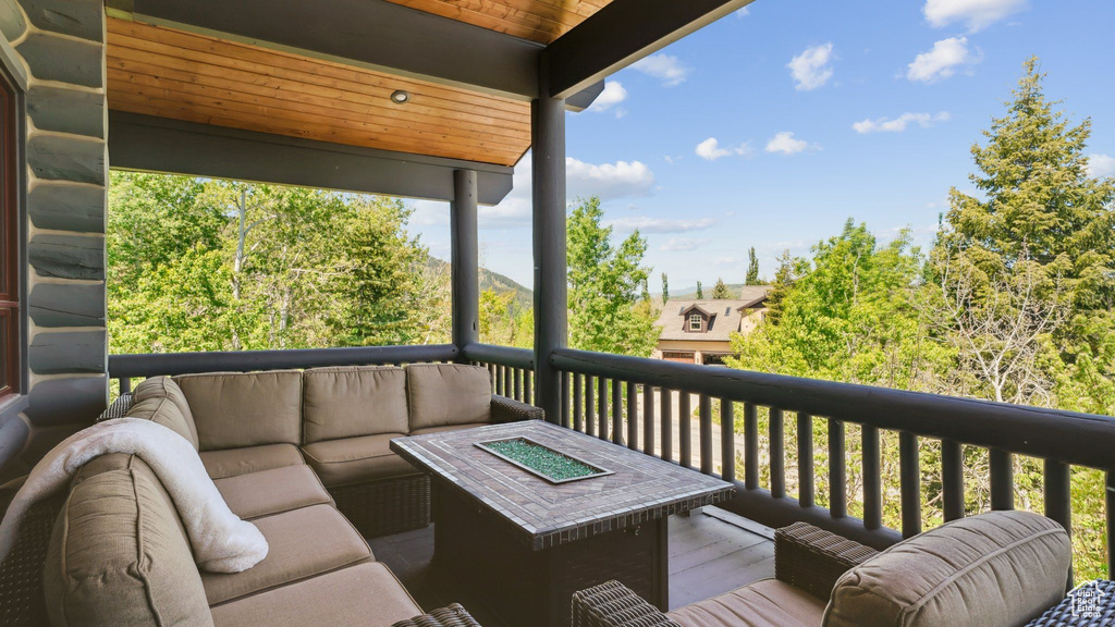 Wooden deck featuring an outdoor living space with a fire pit
