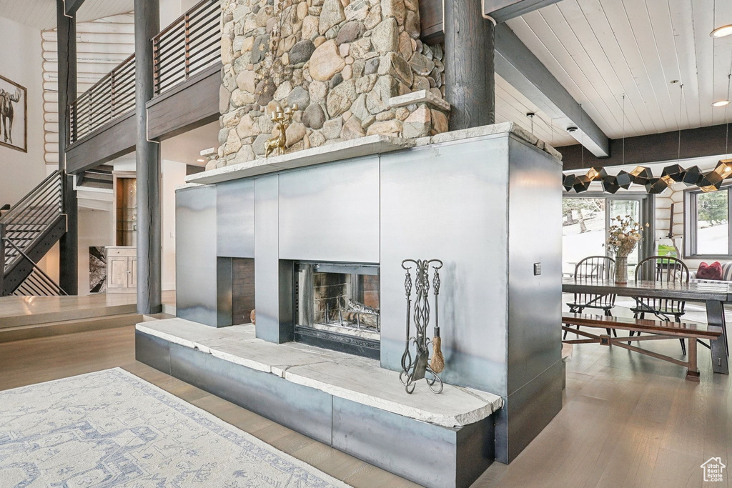Detailed view of wood finished floors and a fireplace with raised hearth