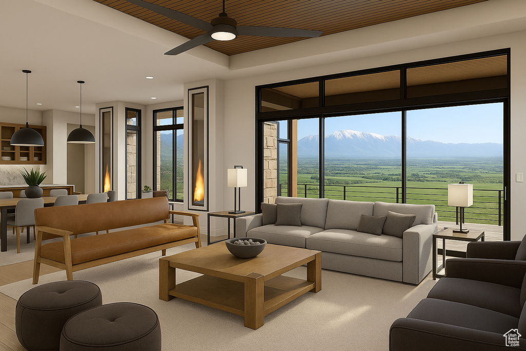 Living area featuring ceiling fan, plenty of natural light, a mountain view, and recessed lighting