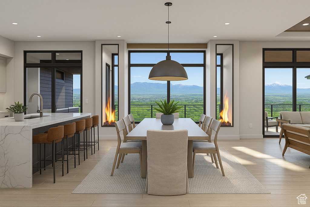 Dining space featuring a mountain view, recessed lighting, light wood-style flooring, and baseboards