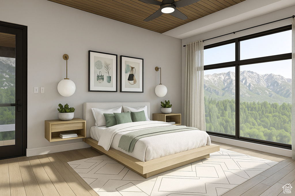 Bedroom featuring wood finished floors, a mountain view, wooden ceiling, and baseboards