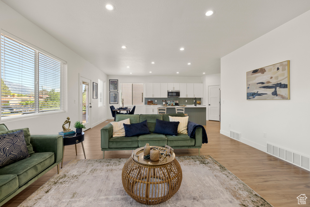 Living room featuring recessed lighting, light wood finished floors, and baseboards