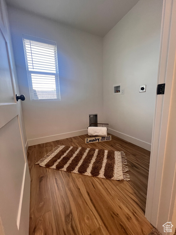 Spare room with baseboards and wood finished floors