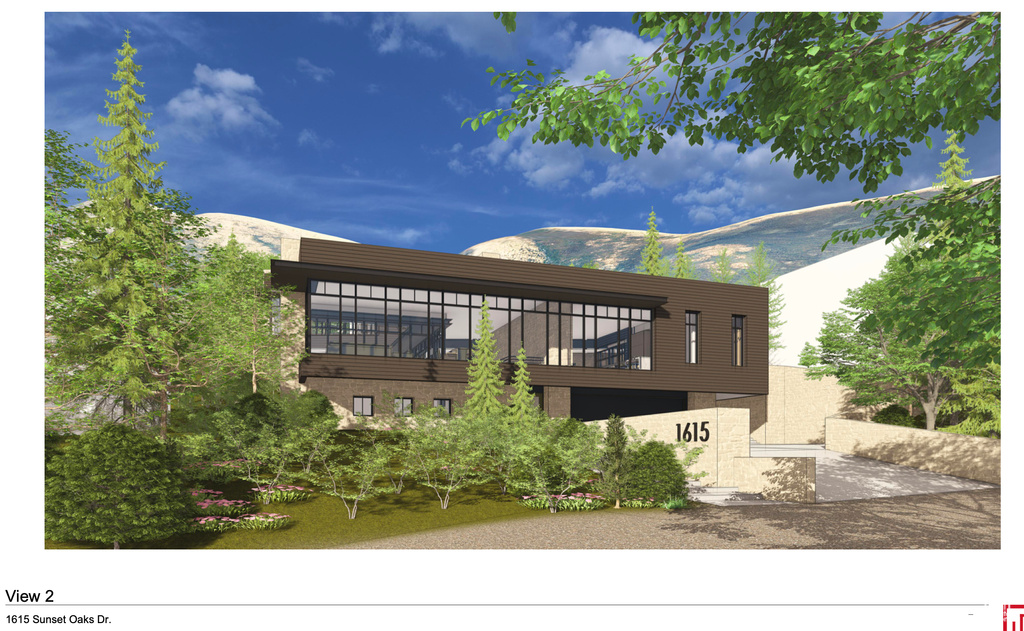 Exterior space with brick siding, a mountain view, and a balcony