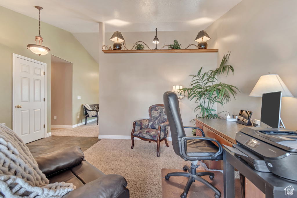 Carpeted office featuring baseboards and lofted ceiling
