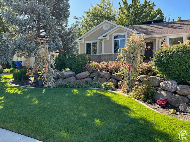 View of home\\\'s exterior featuring stucco siding and a yard
