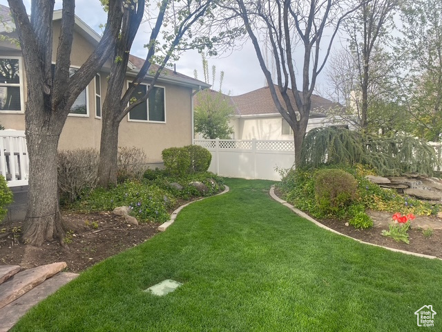 View of yard featuring fence