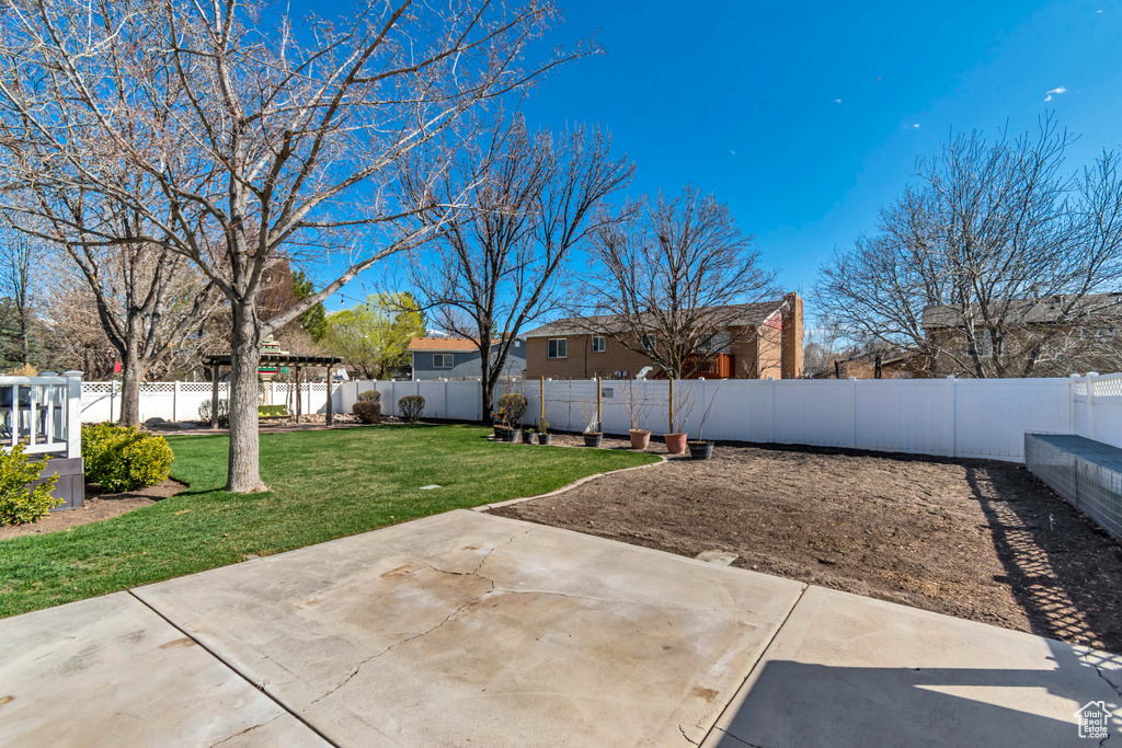 View of yard featuring a fenced backyard and a patio area