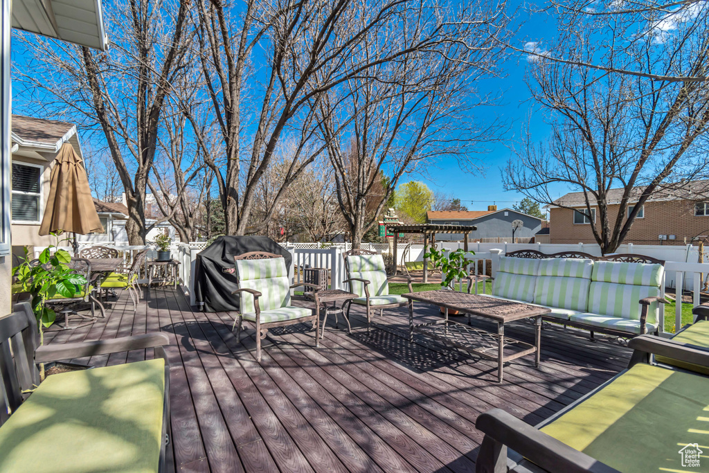 Deck with outdoor lounge area, fence, and outdoor dining space