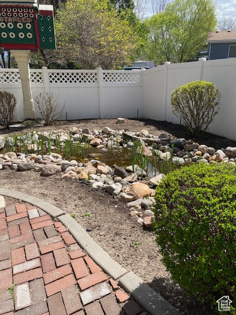View of yard featuring fence