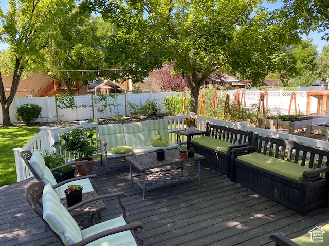 Wooden terrace featuring fence