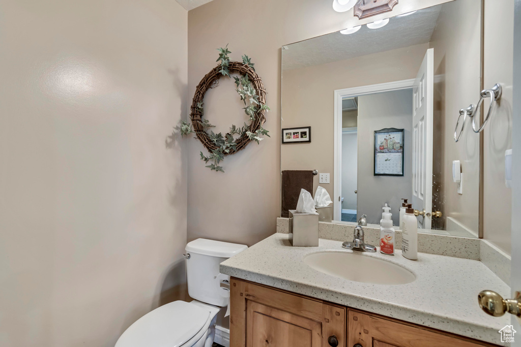 Half bathroom featuring toilet and vanity