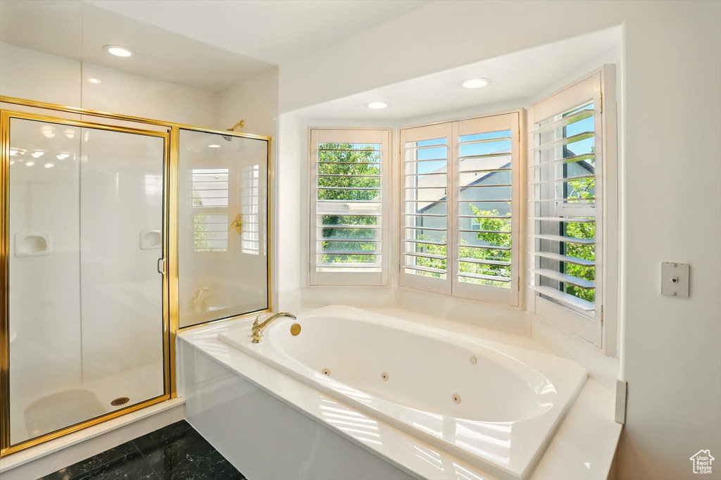 Bathroom with a jetted tub, a stall shower, and recessed lighting