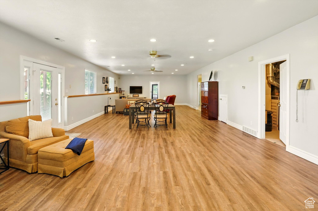 Living room featuring recessed lighting, light wood-type flooring, and a ceiling fan