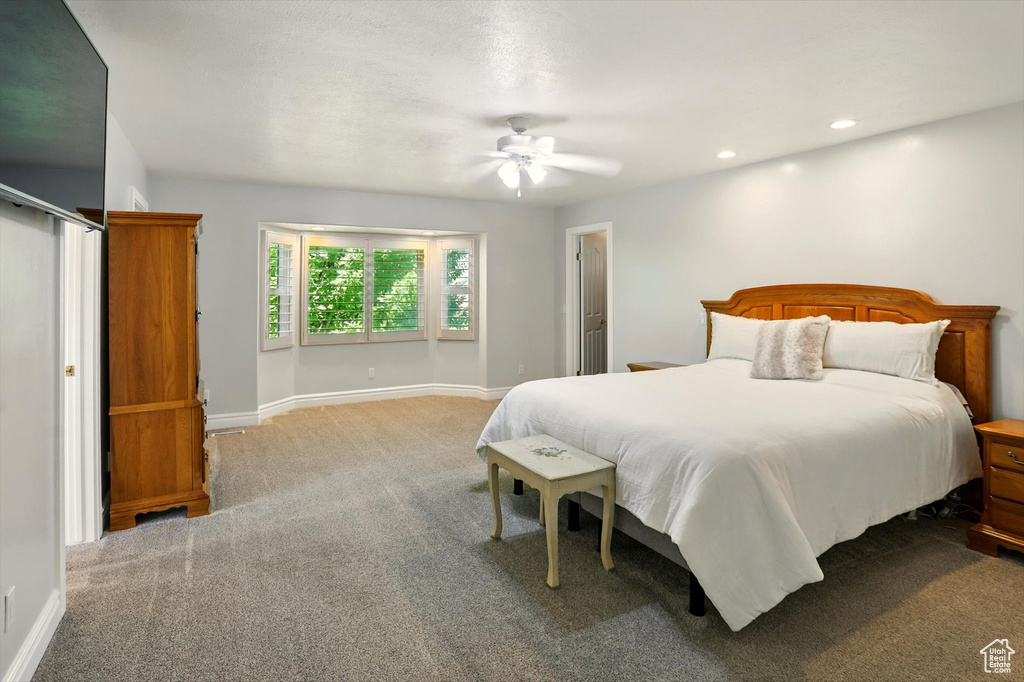 Carpeted bedroom featuring recessed lighting and a ceiling fan