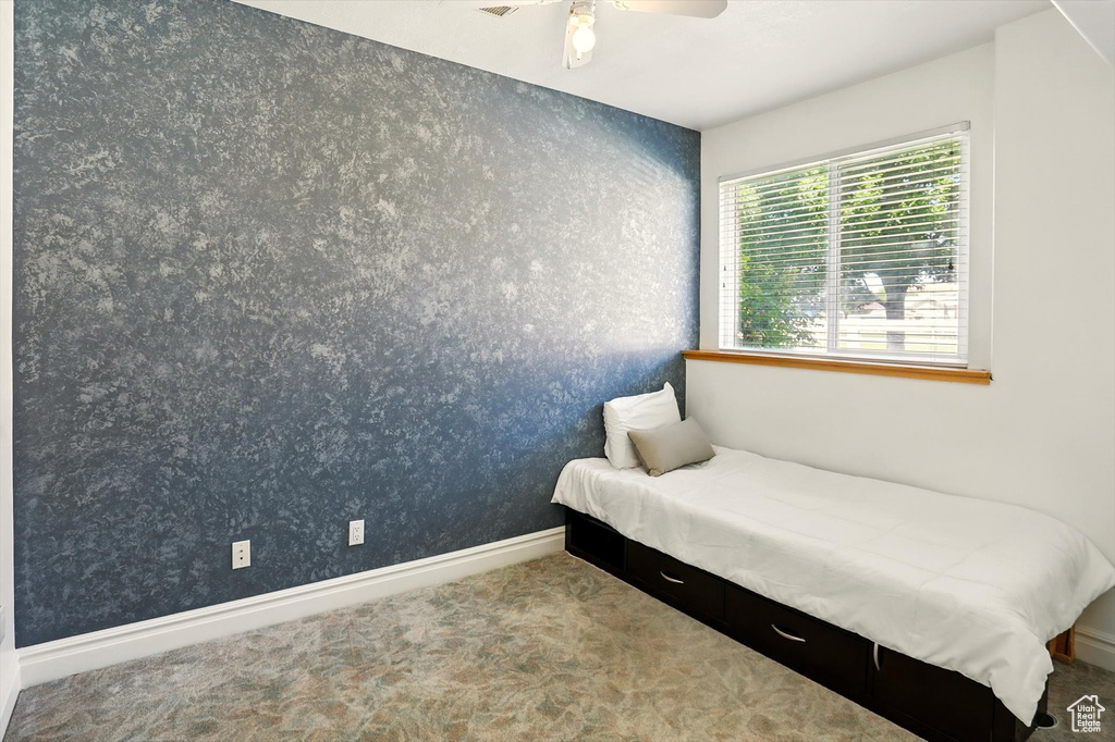 Bedroom with carpet flooring and a ceiling fan