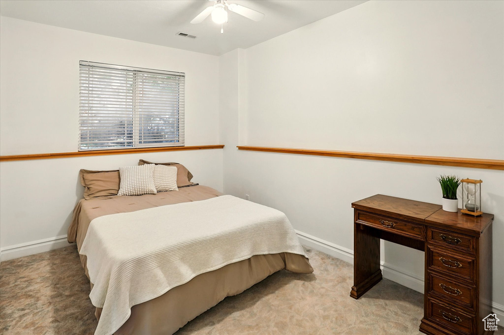 Bedroom featuring light carpet and a ceiling fan