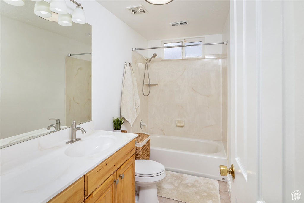 Bathroom featuring vanity, washtub / shower combination, and tile patterned flooring