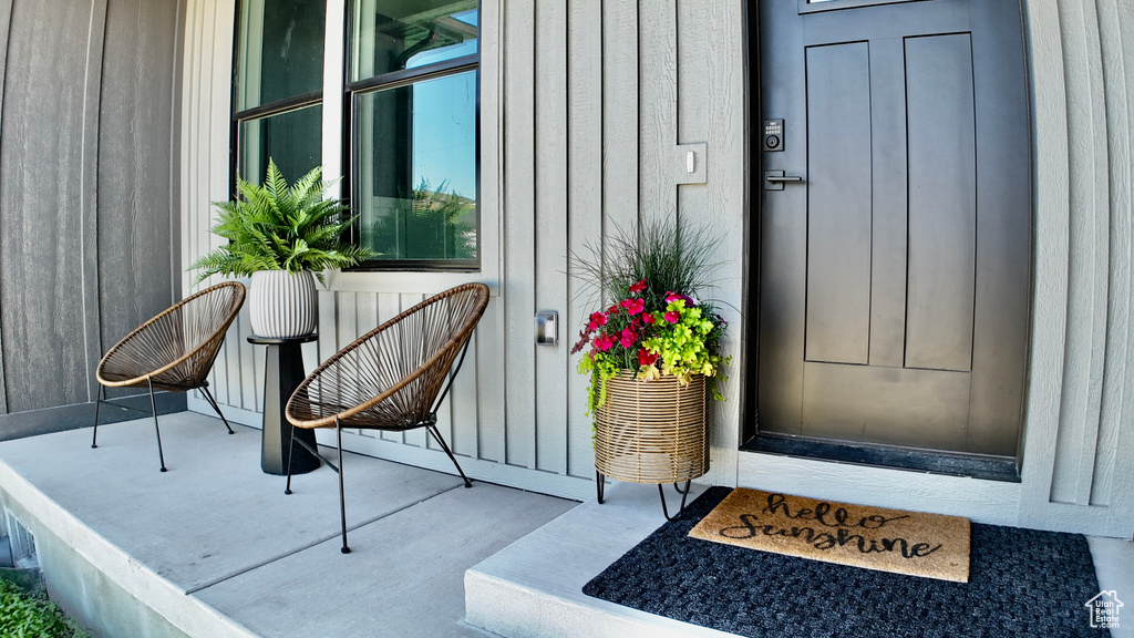 Doorway to property featuring board and batten siding