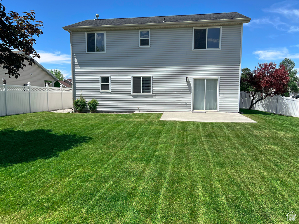 Rear view of house featuring a patio area