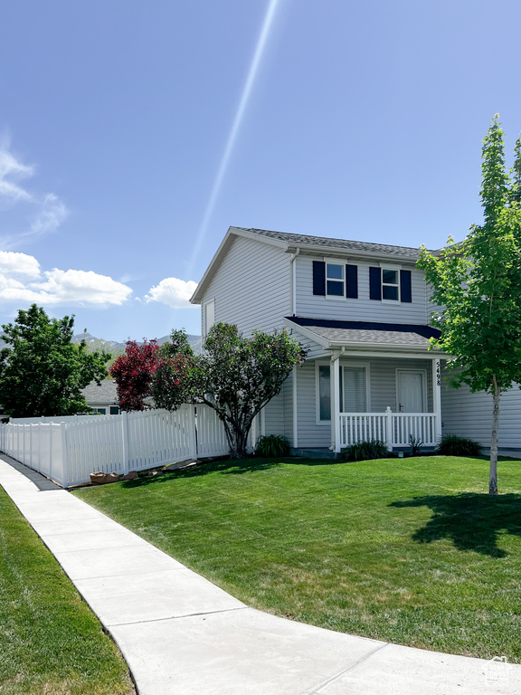 View of side of home featuring covered porch